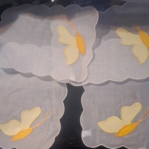 4 GRACEFUL AND BEAUTIFUL WHITE DOILIES WITH YELLOW BUTTERFIES.